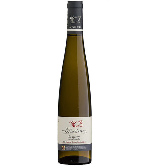 Langwerpige donker bruin-groene fles met een creme-wit label. Hierop staat "The Dry Land Collection" "Longevity"